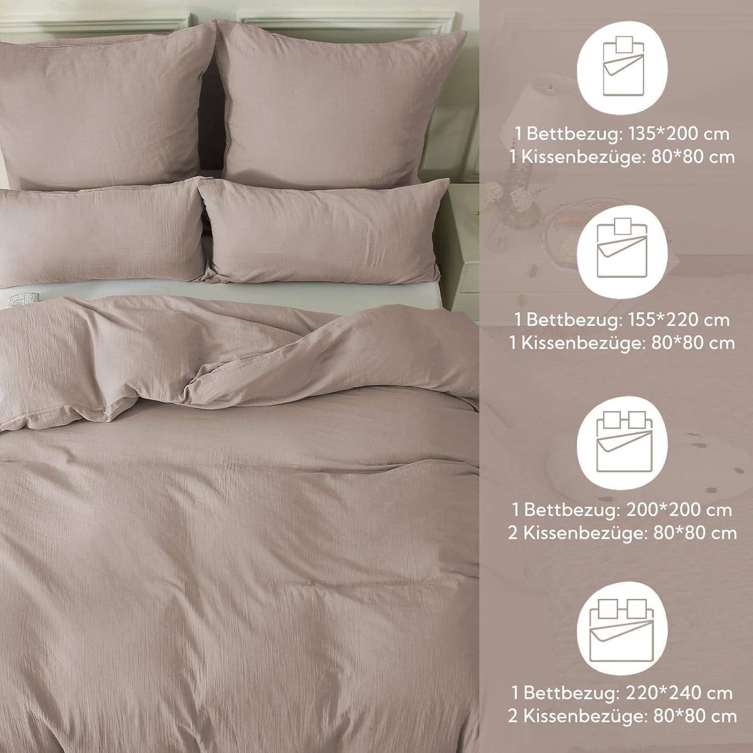 Ein sauber gemachtes Bett mit beigefarbener Bettwäsche und mehreren Kissen, Seitenauflistung der Größen: 135x200 cm, 155x220 cm, 200x200 cm, 220x240 cm.