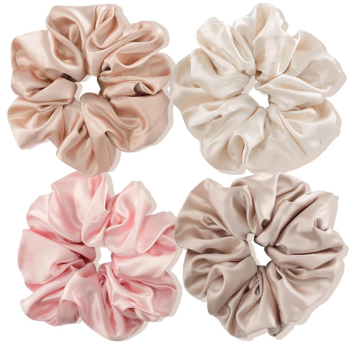 Vier seidenmatte Haargummis in sanften Nuancen von Rosa, Beige und Creme sind auf einem weißen Hintergrund angeordnet.