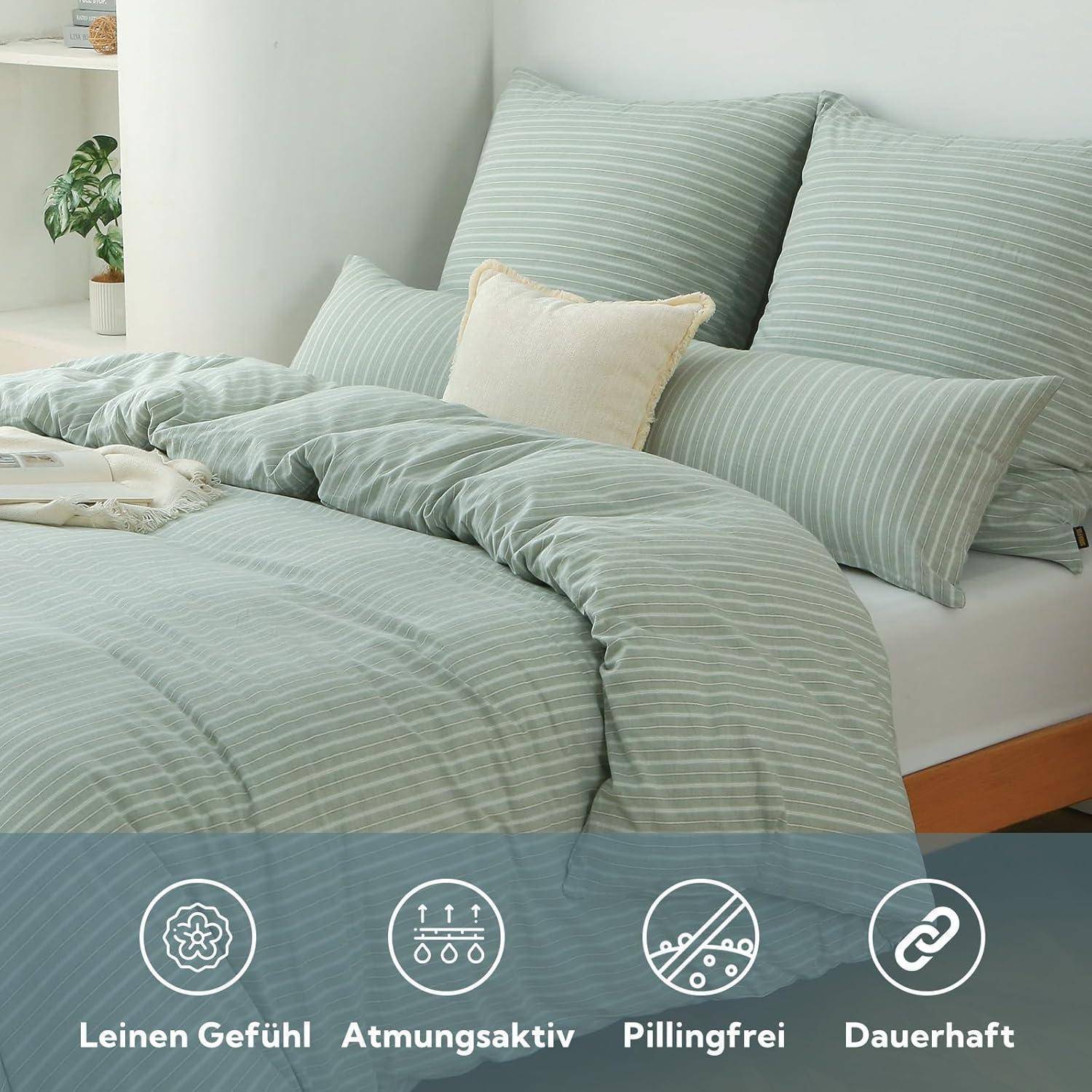 Ein Bett mit hellgrün gestreifter Bettwäsche, Kissen und einem beigen Kissen. Symbole darunter zeigen Eigenschaften: Leinengefühl, atmungsaktiv, pilling-frei, langlebig.