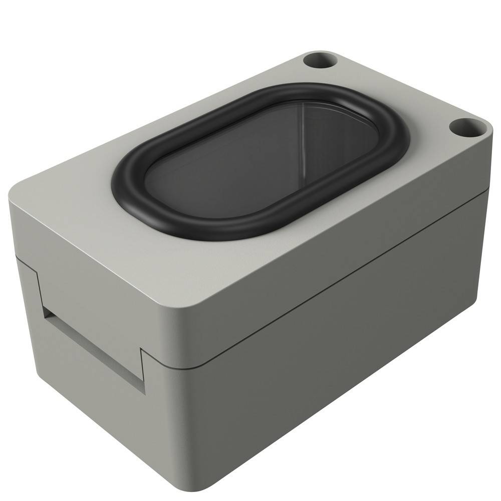 Ein rechteckiges graues elektronisches Gerät mit einem schwarzen ovalen Element auf der Oberseite und Löchern an zwei Ecken, möglicherweise zur Aufnahme eines Lautsprechers oder Sensors.