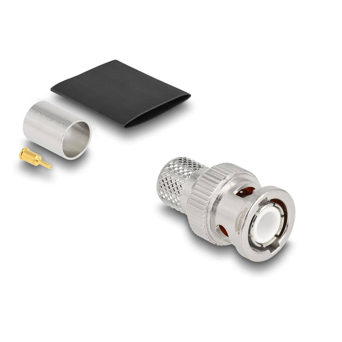 Ein demontierter Koaxialkabelstecker besteht aus einem Metallstecker, einer Metallhülse, einem kleinen Messingpin und einem schwarzen Schrumpfschlauch.