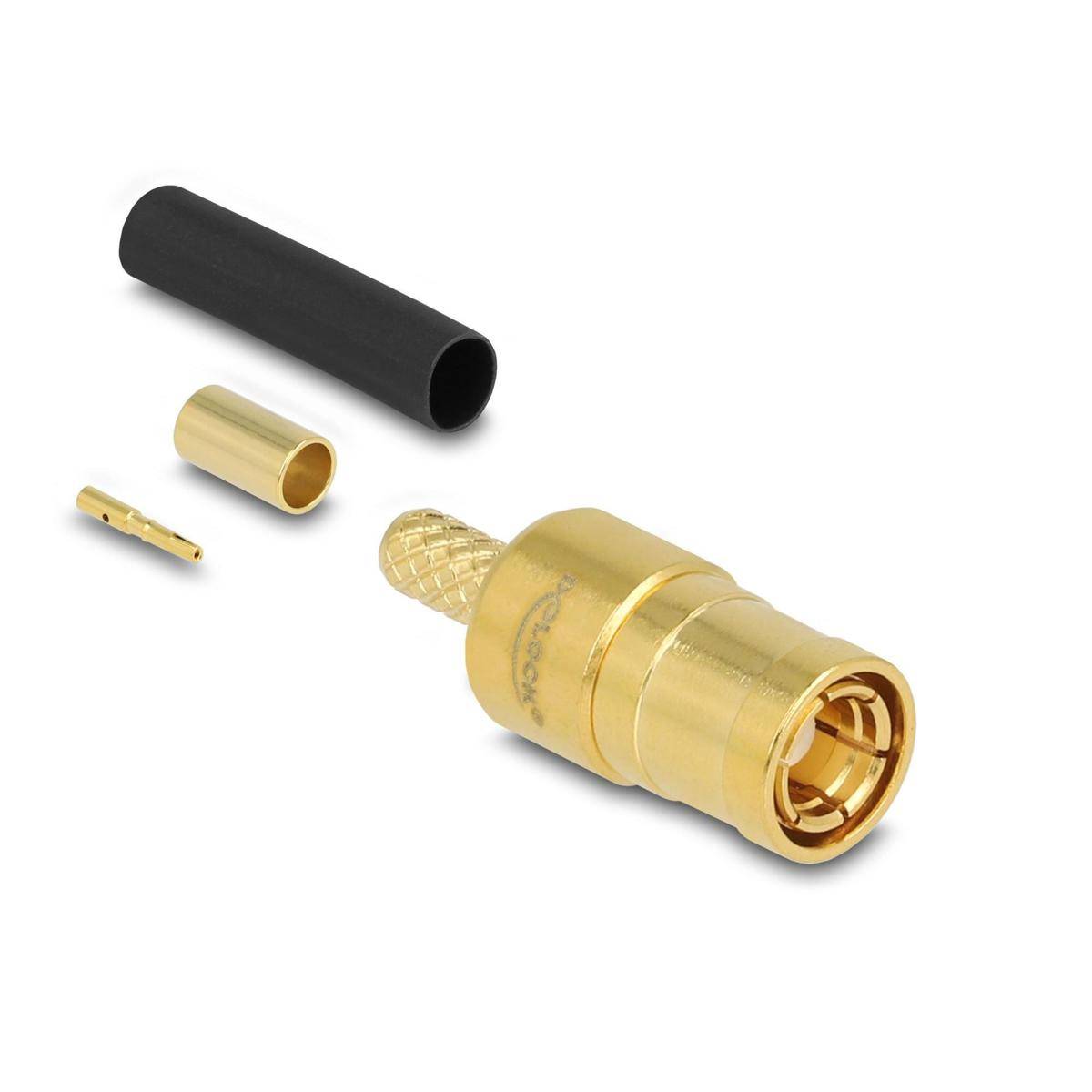 Ein goldener SMA-Stecker ist in vier Teile zerlegt dargestellt: Außengehäuse, Innenring, Stift und schwarzer Schrumpfschlauch.