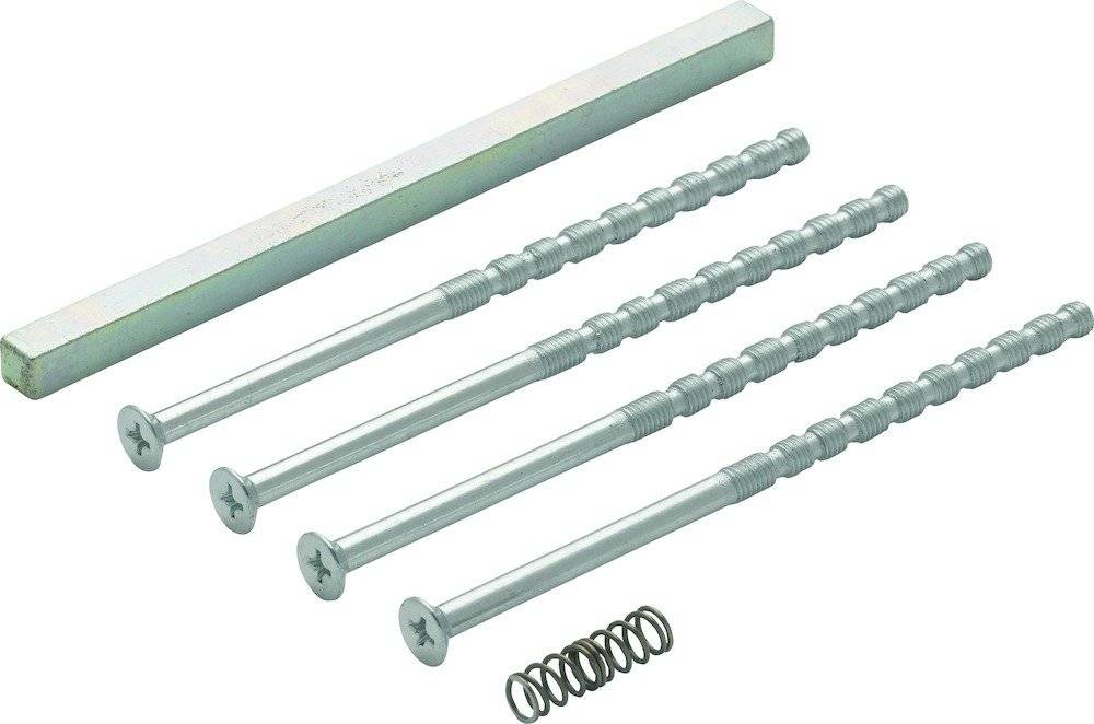 Ein Satz langer Schrauben, eine Metallstange und eine Feder auf weißem Hintergrund angeordnet, wahrscheinlich Komponenten zum Zusammenbau von Möbeln.