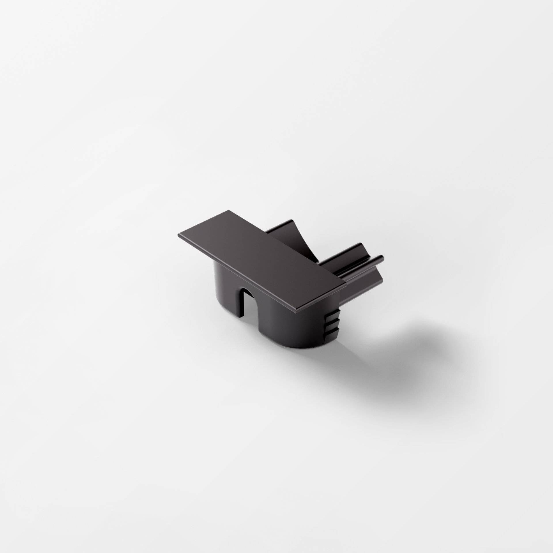 Ein schlankes, minimalistisches schwarzes Objekt mit einem kleinen, kantigen Design auf weißem Hintergrund, das einen sanften Schatten wirft.