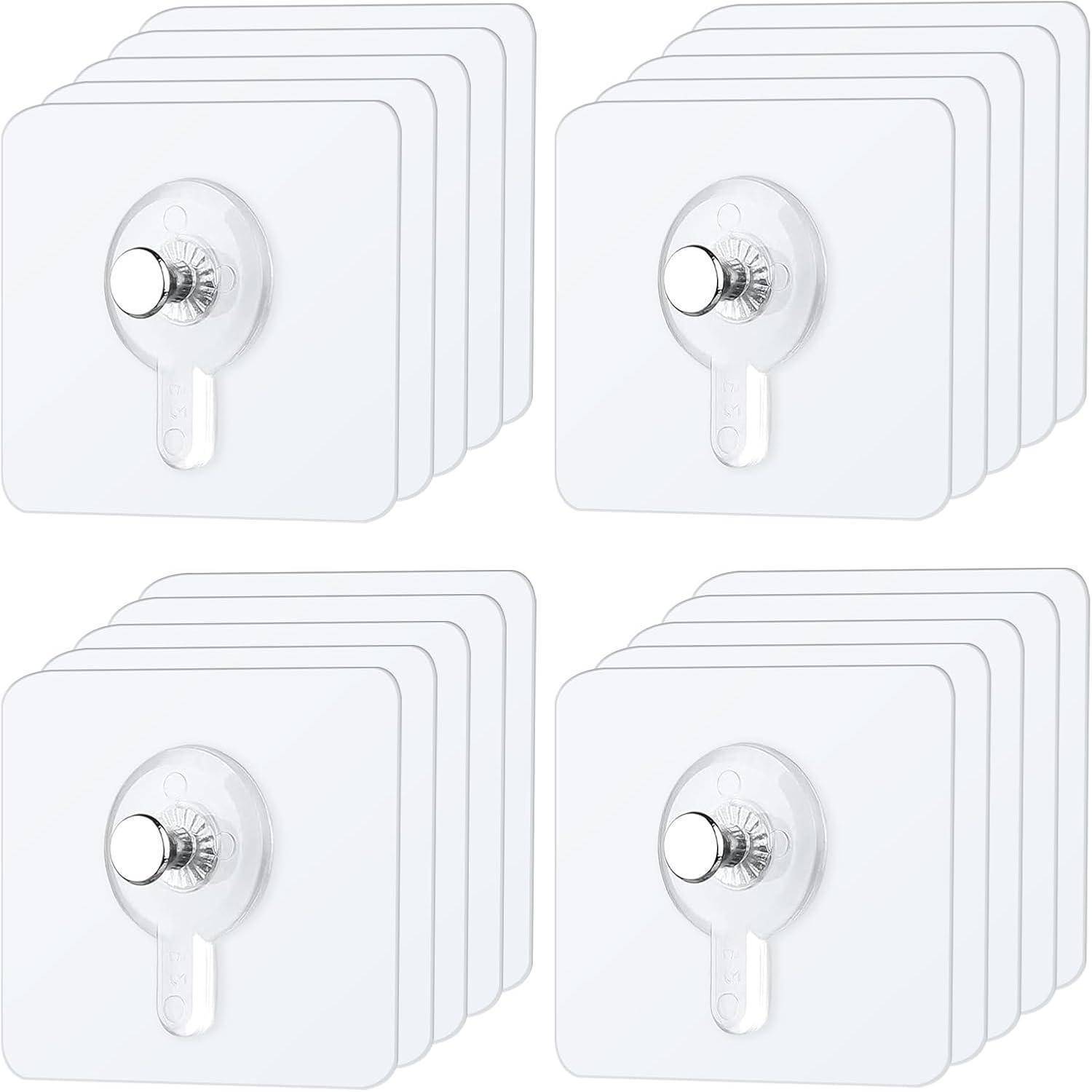 Vier Sätze transparenter Klebehaken für die Wand, in einem Raster angeordnet, jeweils mit einem silbernen Haken und einer quadratischen Basis, geeignet zum Aufhängen von Gegenständen.