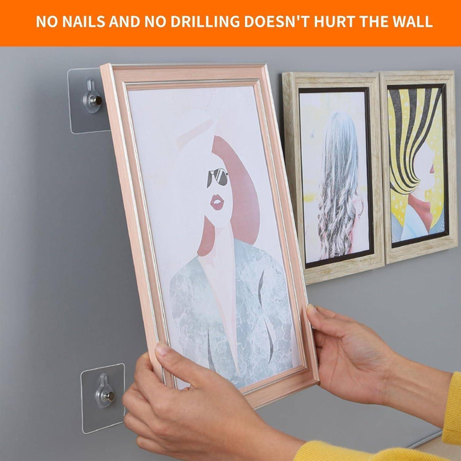Eine Person richtet einen Bilderrahmen an der Wand mit Klebemontagen aus. Der Text lautet: „Keine Nägel und kein Bohren beschädigt die Wand nicht.