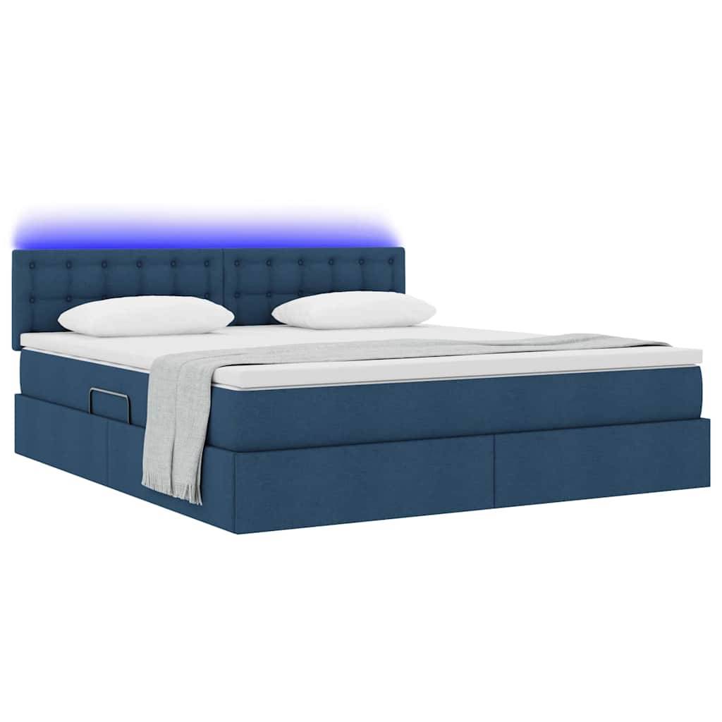 Ein modernes blaues Plattformbett mit zwei weißen Kissen und einer hellgrauen Decke. Das Kopfteil ist gepolstert, und das Bett hat eine blaue Unterbeleuchtung.