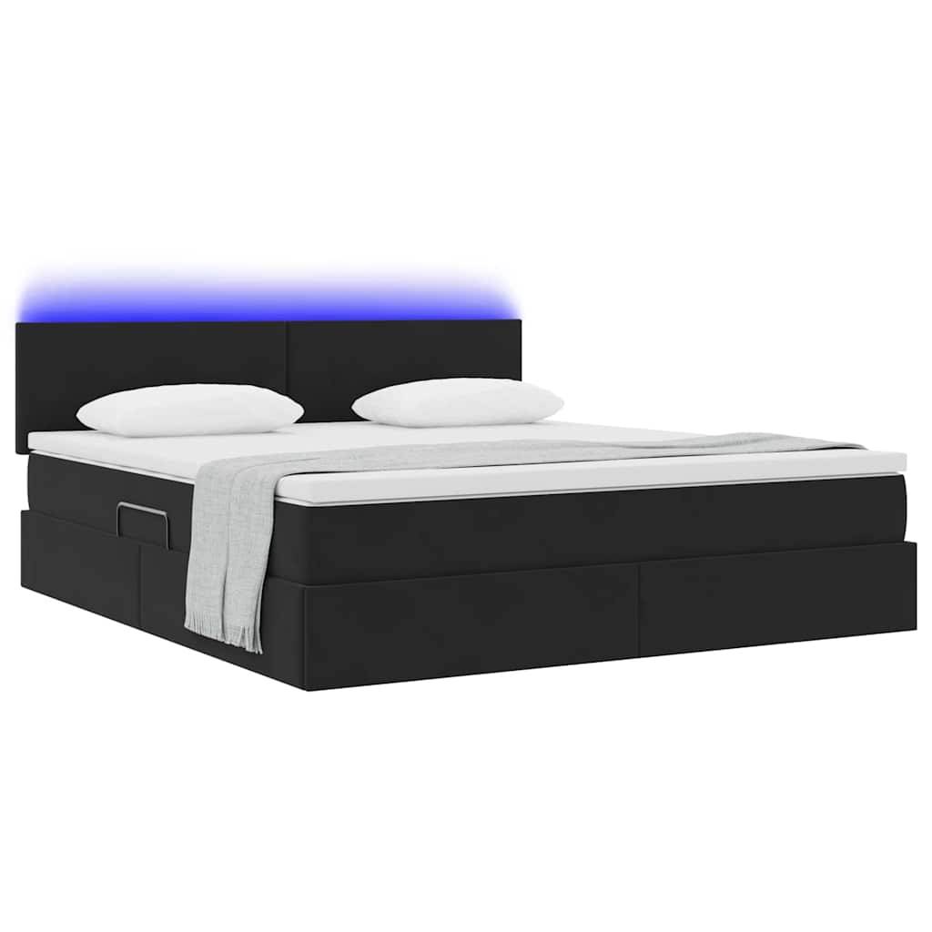 Ein modernes schwarzes Bett mit zwei Kissen und einer hellgrauen Decke. Das Kopfende ist mit einem subtilen blauen Licht beleuchtet und erzeugt damit ein elegantes Aussehen.