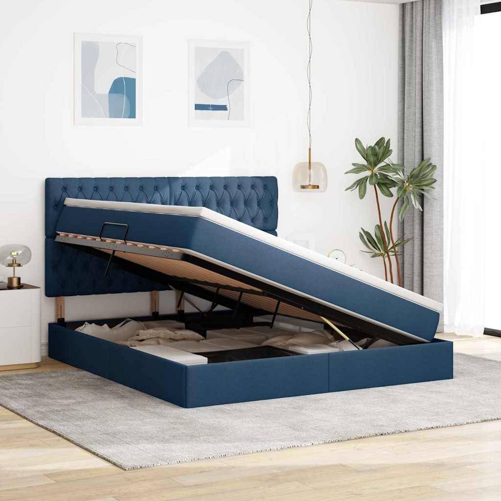 Ein modernes Schlafzimmer mit einem blau gepolsterten Stauraumbett, angehoben um den Stauraum freizulegen. Zwei abstrakte Kunstwerke und eine Pflanze sind sichtbar.