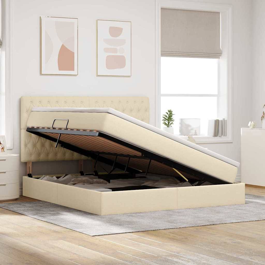 Ein beige gepolstertes Bett mit einer Matratze, die sich durch einen hydraulischen Liftemechanismus öffnen lässt, gibt Stauraum darunter frei. Zwei abstrakte Gemälde hängen über dem Bett; der Raum ist gut beleuchtet.