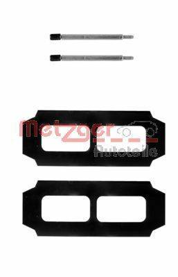 Rechteckige schwarze Metallplatten mit zwei Aussparungen und einem kleinen Metallinstrument darüber. Wahrscheinlich Komponenten für die Automobilindustrie.