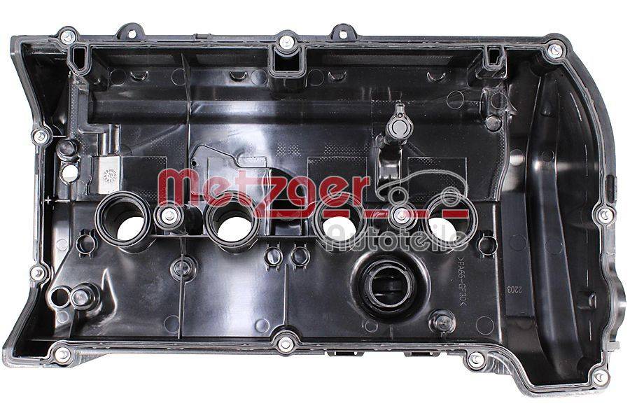 Ein schwarzer Motorventildeckel mit mehreren Befestigungslöchern und Öffnungen, beschriftet mit 'metzger Autoteile'.
