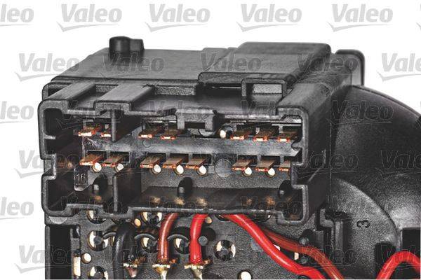 Ein Automotive-Elektroanschluss mit sichtbaren Kupferpins und roten Kabeln, auf dem der Markenname 'Valeo' im Hintergrund mehrfach zu sehen ist.