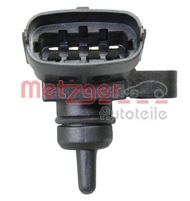Ein Fahrzeugsensor mit der Bezeichnung 'Metzger Autoteile', ausgestattet mit einem schwarzen Kunststoffgehäuse, in dem mehrere leitfähige Anschlüsse sichtbar sind.
