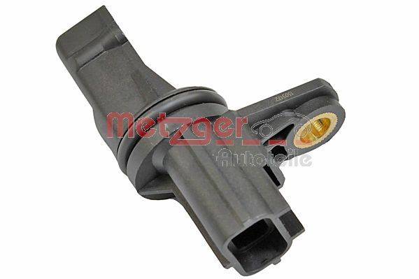 Ein schwarzer Autosensor mit einer kreisförmigen Basis und einem rechteckigen Stecker, der in einem Winkel gezeigt wird und Teilenummertext anzeigt.