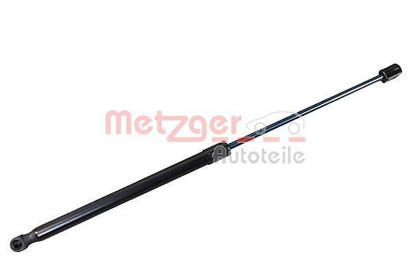 Eine Motorhaubenstrebe mit einer Metallstange und einem zylindrischen Körper; mit der Beschriftung 