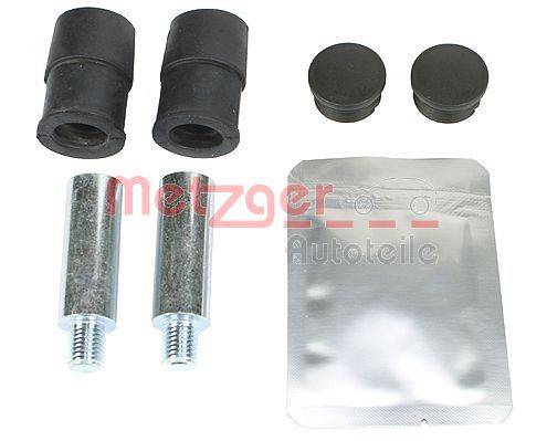 Autoteileset mit zwei Gummibuchsen, zwei Metallstiften und einem versiegelten Paket. Komponenten sind auf einer flachen Oberfläche angeordnet.