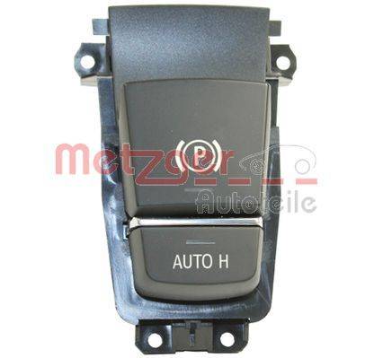Elektrische Feststellbremstaste mit 'AUTO H'-Knopf für die automatische Haltefunktion, in einem Kunststoffgehäuse montiert.