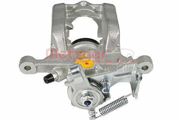 Ein Metallautoteil, genauer gesagt eine Bremssattel, mit sichtbaren Federn und Befestigungskomponenten, der ein robustes, industrielles Design aufweist.