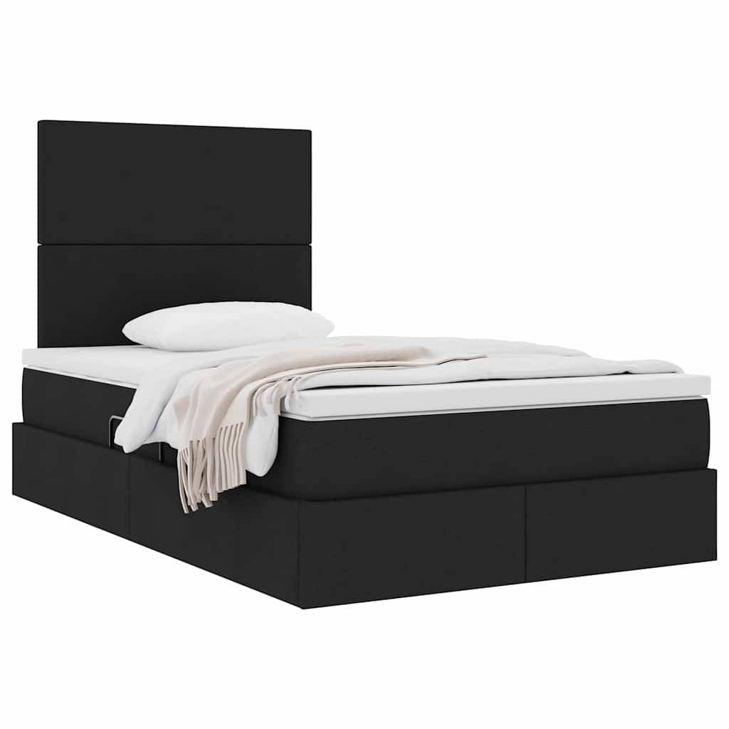Ein modernes schwarzes Plattformbett mit einer weißen Matratze, weißem Kissen und einer hellbeigen Decke, die über die Seite hängt.