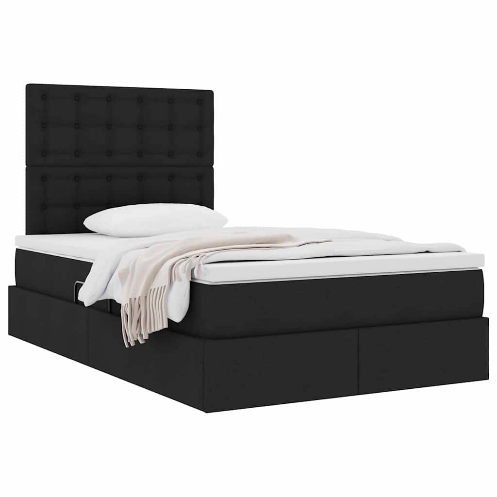 Ein modernes schwarzes Bett mit gepolstertem Kopfteil, einer weißen Matratze und einer gefalteten beigefarbenen Decke. Es hat Stauraum-Fächer darunter.