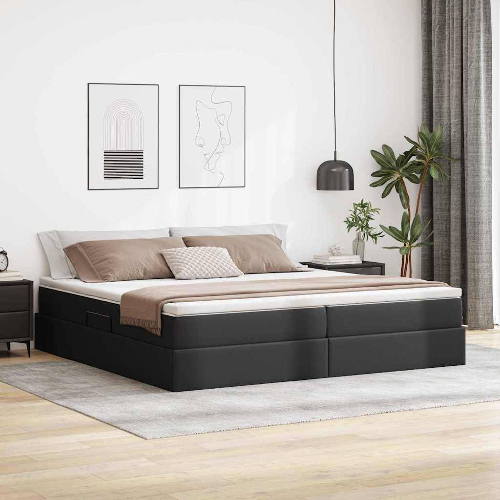 Ein modernes Schlafzimmer mit einem schwarzen Plattformbett, beigefarbiger Bettwäsche, zwei abstrakten Linienkunstrahmen darüber, einer Topfpflanze daneben und natürlichem Licht.