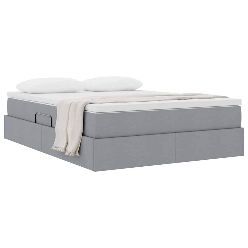 Ein Plattformbett mit einer hellgrauen Basis, weißer Matratze und beiger Decke, das einen Schubfach an der Seite zur Aufbewahrung hat.