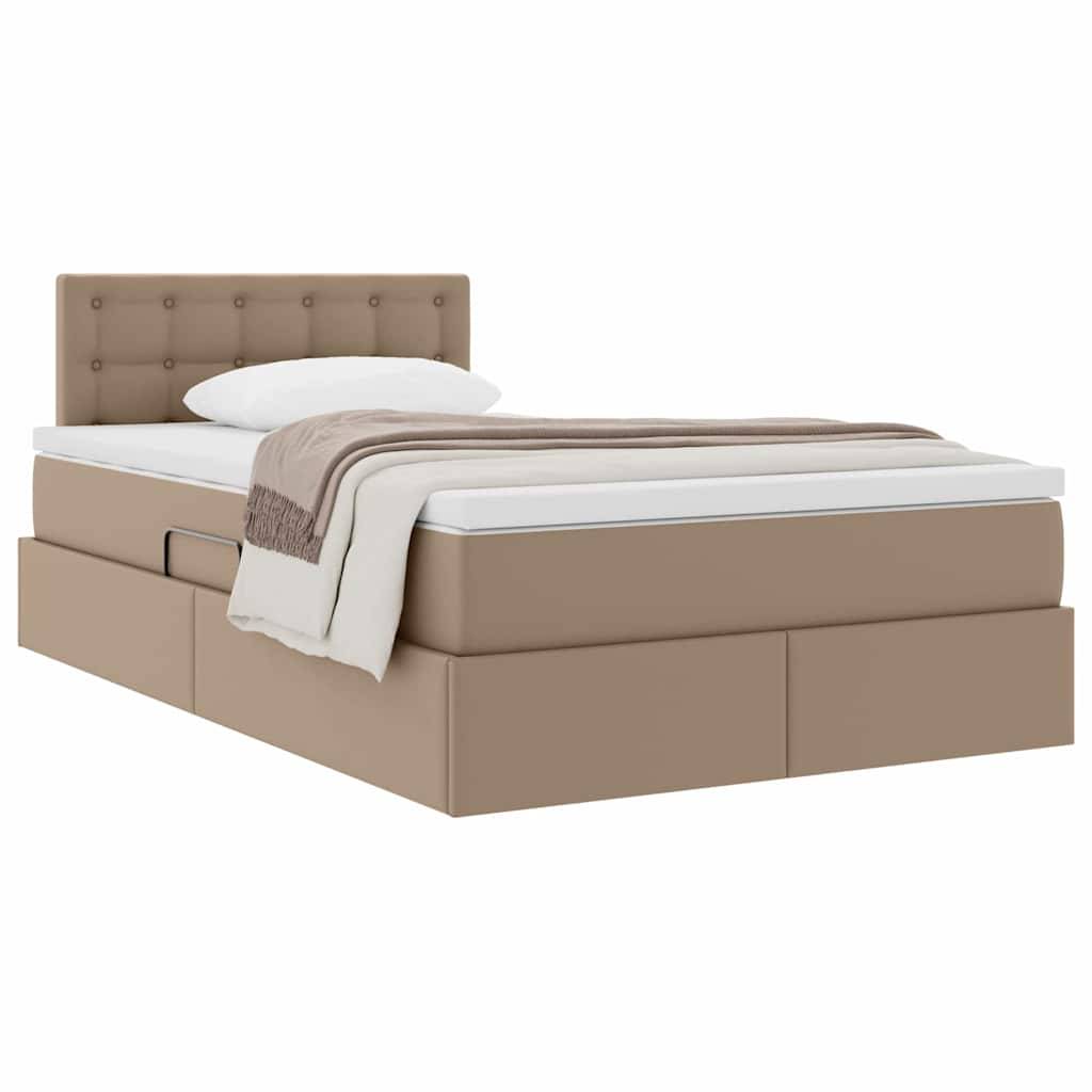 Ein beige getuftetes Bett mit einem weißen Kissen, weiß-brauner Bettwäsche und Staurageschubladen darunter.