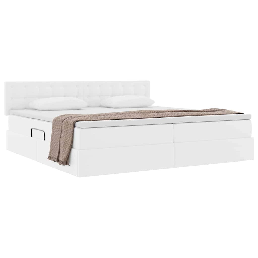 Ein modernes weißes Plattformbett mit gepolstertem Kopfteil, zwei Kissen und einer braun gemusterten Decke, die am Fußende des Bettes gefaltet ist.