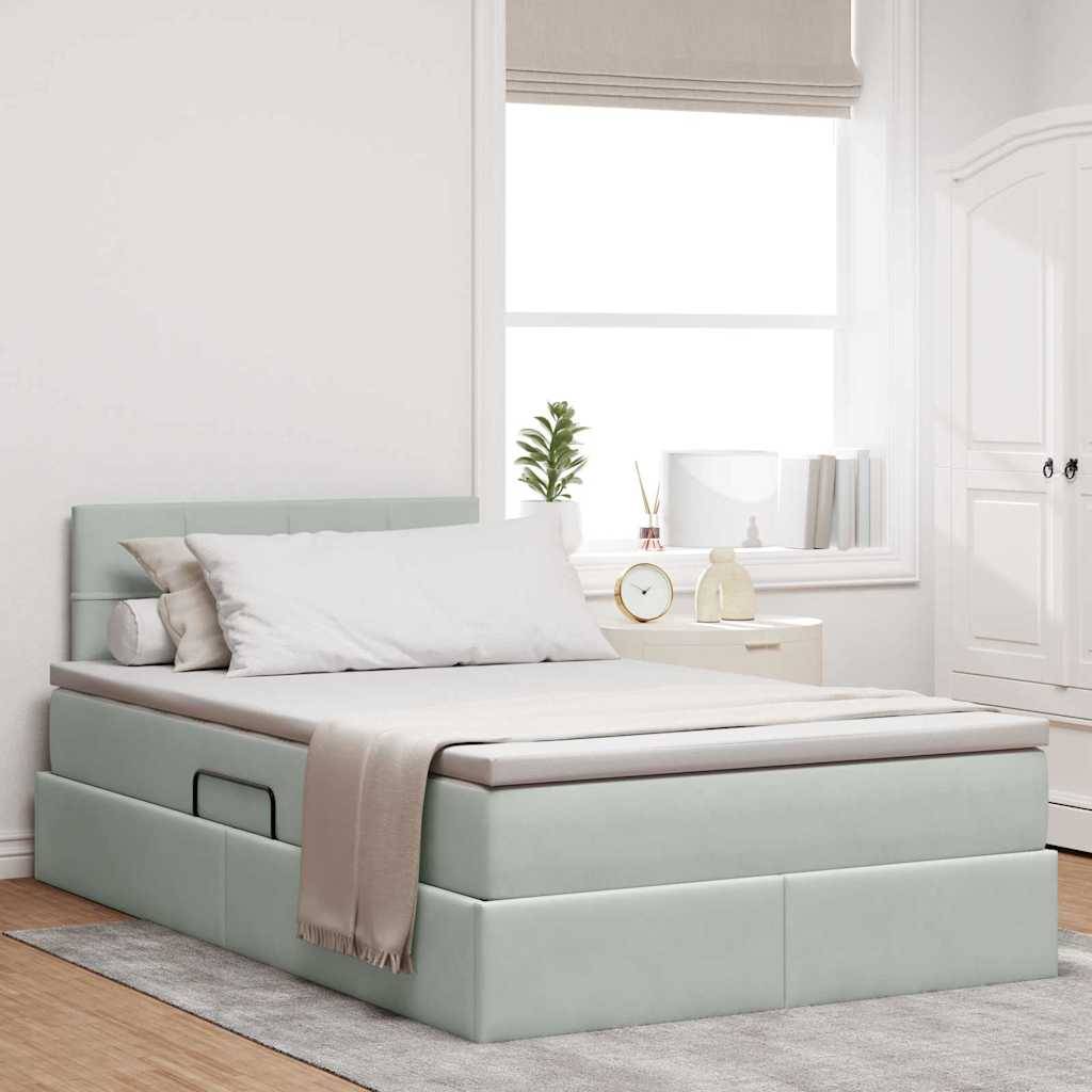 Schlafzimmer mit einem modernen Bett, weißer Bettwäsche und einer beigen Wurfdecke. Ein Fenster, Pflanzen und ein Lagerschrank schaffen eine ruhige und aufgeräumte Atmosphäre.