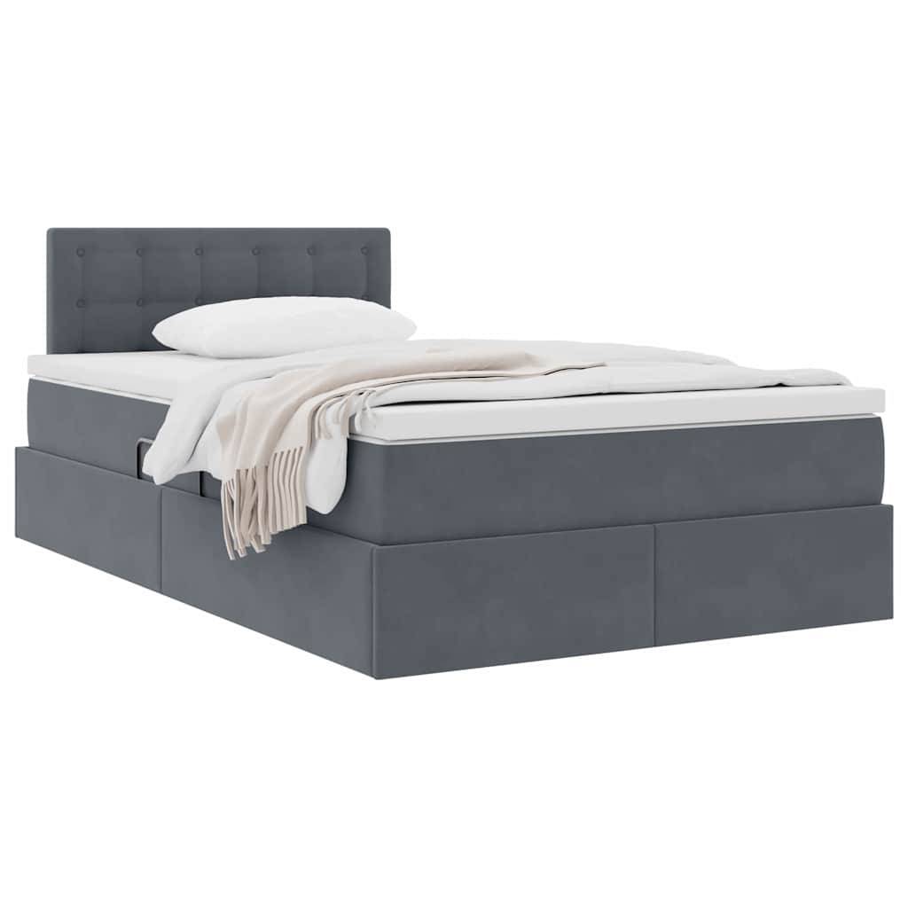 Ein modernes graues Plattformbett mit gestepptem Kopfteil, weißer Matratze, Kissen und beigem Wurfdeckel über der Seite drapiert.