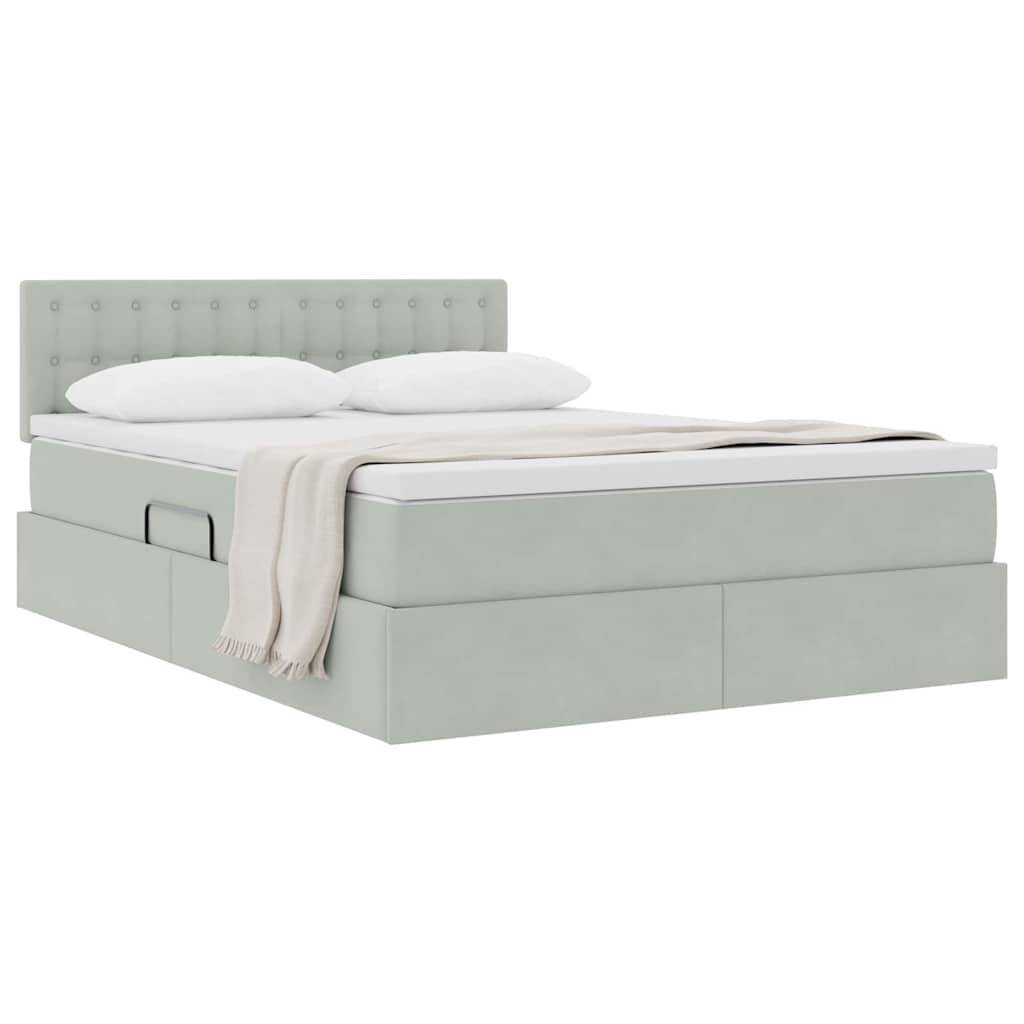 Ein sorgfältig gemachtes Bett mit gestepptem Kopfende, zwei Kissen, einer gefalteten beigefarbenen Decke und Schubladen zur Aufbewahrung darunter.