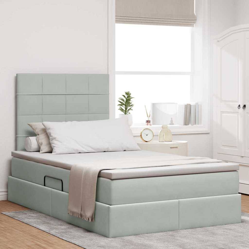 Schlafzimmer in Hellgrau mit einem modernen gepolsterten Bett, weißen Kissen und einer beigen Decke. Die minimalistische Einrichtung umfasst eine kleine Topfpflanze und eine Lampe auf einem Nachttisch.