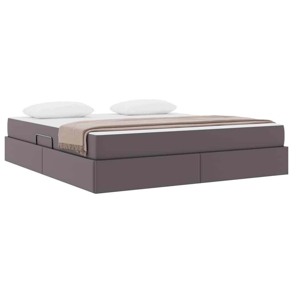 Ein modernes Doppelbett mit einem gepolsterten grauen Rahmen und zwei weißen Kissen, bedeckt mit einer beigen Decke, vor einem weißen Hintergrund.