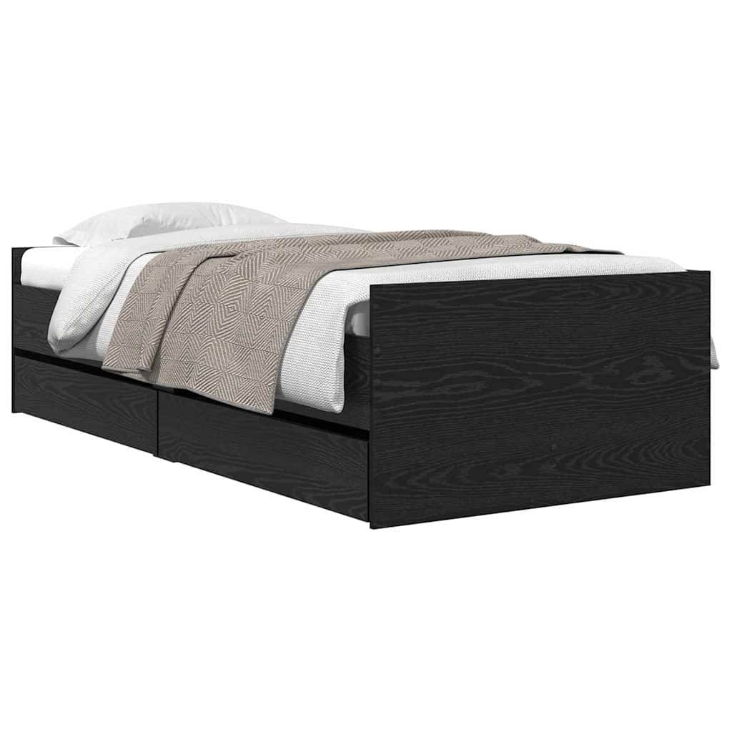 Ein schwarzer Holzbettrahmen mit zwei Schubladen an der Seite, eine weiße Matratze und eine beige Fischgrät-gemusterte Decke.