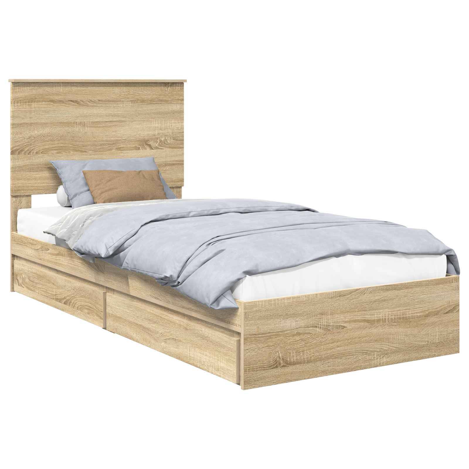 Ein Holzbett mit zwei Schubladen darunter, versehen mit einem Kopfteil. Das Bett ist ordentlich bezogen mit einem hellblauen Bettdecken und mehreren Kissen.