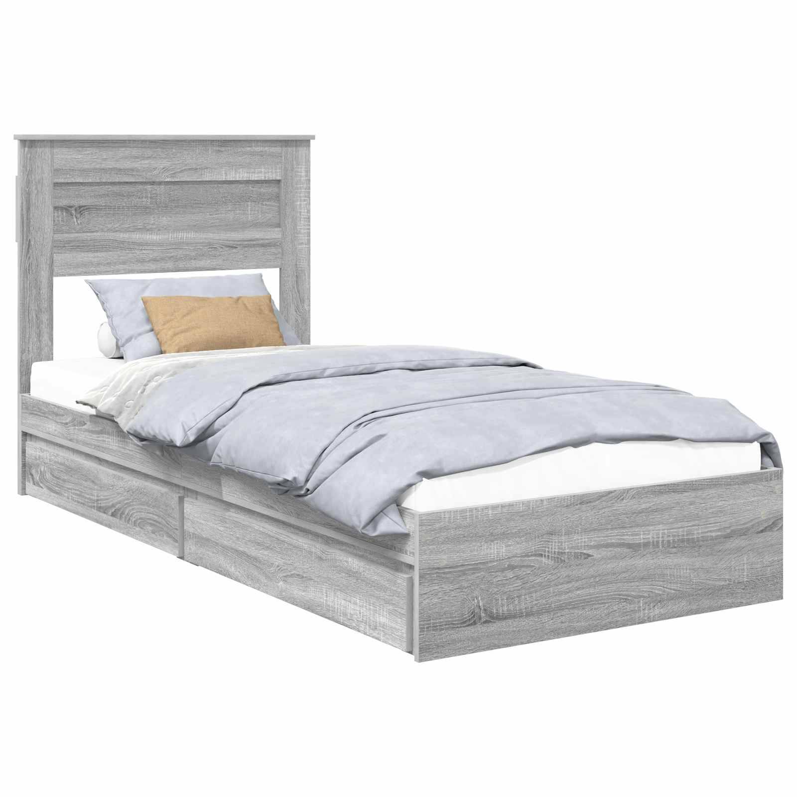 Ein grauer Holzbett mit einem Kopfteil, zwei Bettschubladen und hellblauen Bettwäsche. Ein Kissen ist in Tanfarbe abgesetzt.