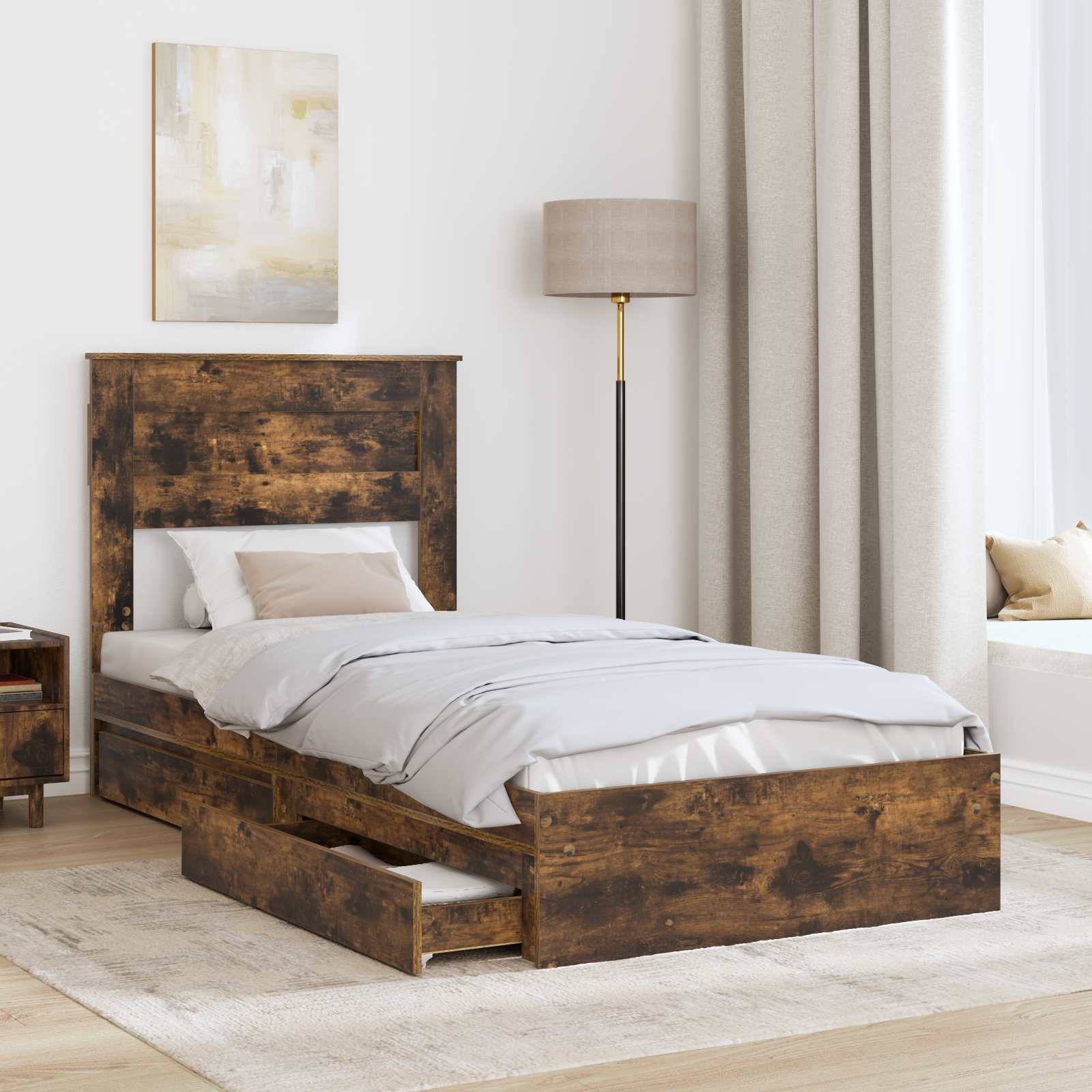 Ein rustikales Holzbett mit Kopfteil, weißer Bettwäsche und einer offenen Schublade an der Basis. Ein Nachttisch und eine Stehlampe stehen daneben.