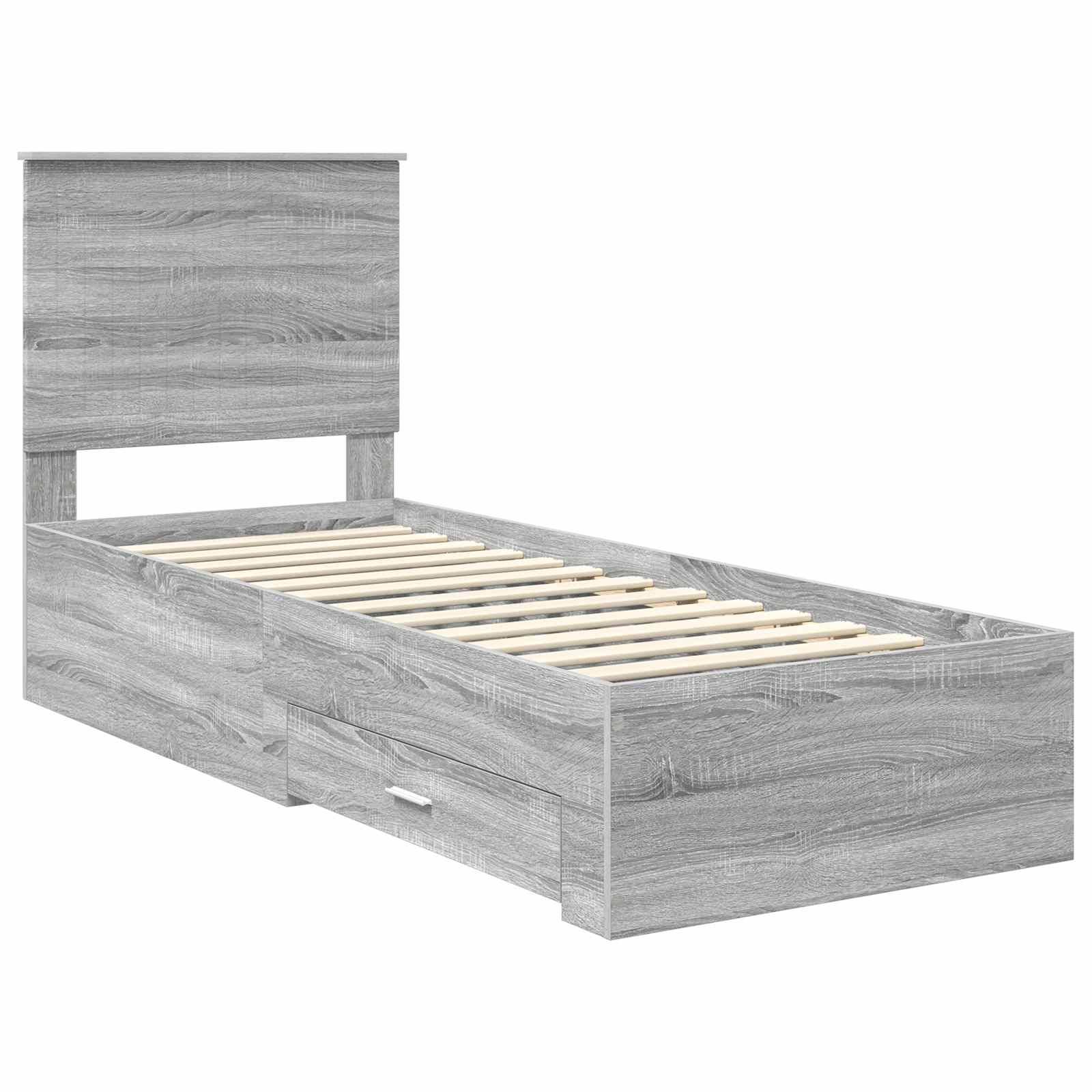 Ein grauer Holz-Zwillingsbettrahmen mit Kopfteil und integrierten Aufbewahrungsschubladen darunter, mit sichtbaren Latten zur Matratzenunterstützung.