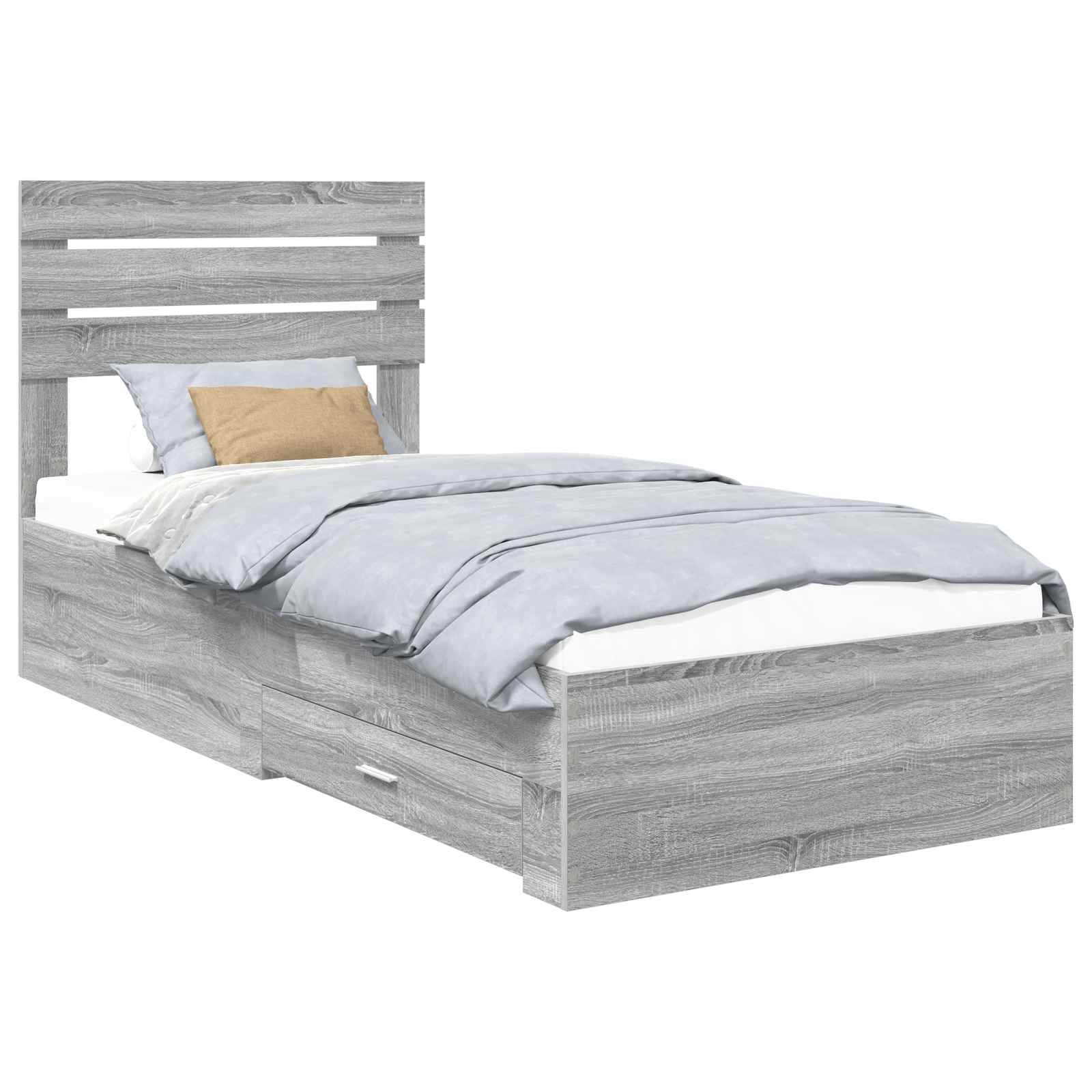 Ein einzelnes Holzbett mit einer hohen, geschlitzten Kopfseite in hellem Grau, ausgestattet mit einer blauen Bettdecke, zwei Kissen und einer Schublade unter dem Bett.