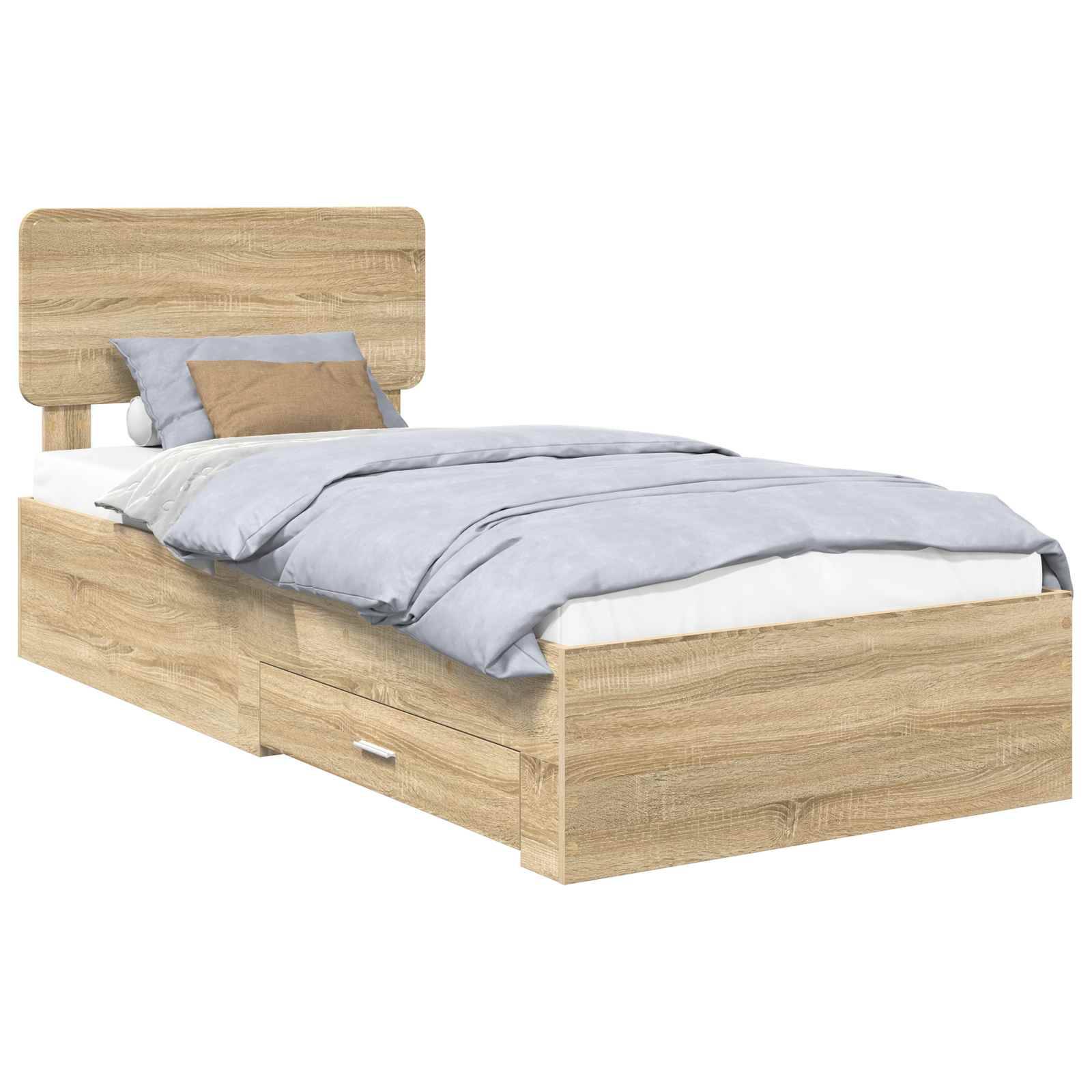 Ein Holzbett mit einer Aufbewahrungsschublade darunter. Es verfügt über einen Holzkopfteil und ist in einer hellen Eichenoberfläche gearbeitet. Das Bett ist mit grauer Bettwäsche und zwei Kissen bezogen, eines in braun und eines in der gleichen Farbe wie die Bettwäsche.