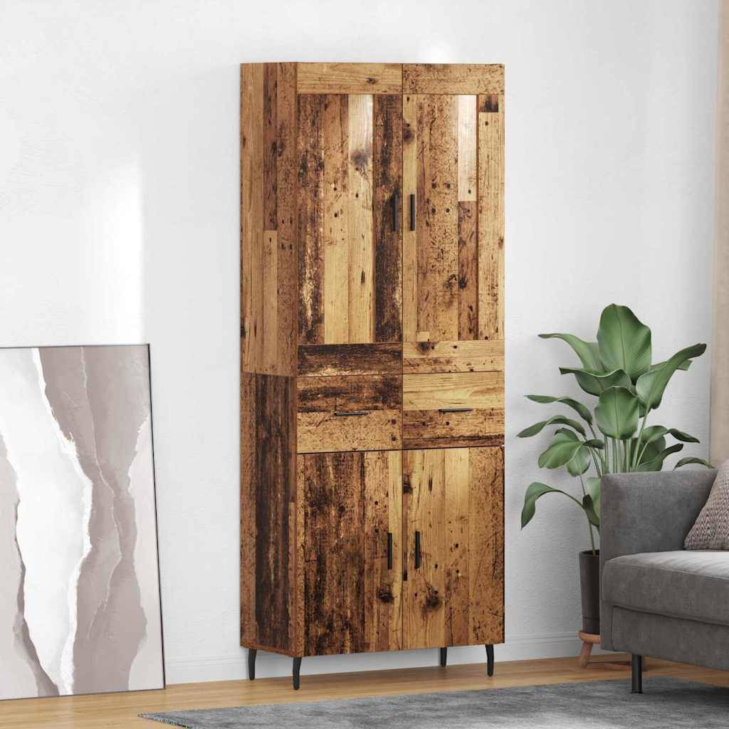 Ein hoher Holzschrank mit Patchwork-Muster steht neben einer Topfpflanze und einem grauen Sofa in einem modernen Wohnzimmer, in dem ein gerahmtes abstraktes Kunstwerk auf dem Boden liegt.