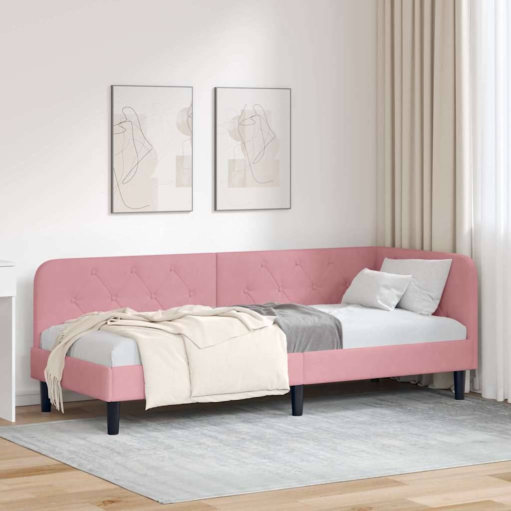 Ein rosa bezogenes Bett mit Polsterung, versehen mit einer beigen Decke und einem Kissen auf einem grauen Teppich in einem minimalistischen Raum mit abstrakter Wandkunst und einem kleinen weißen Schreibtisch.