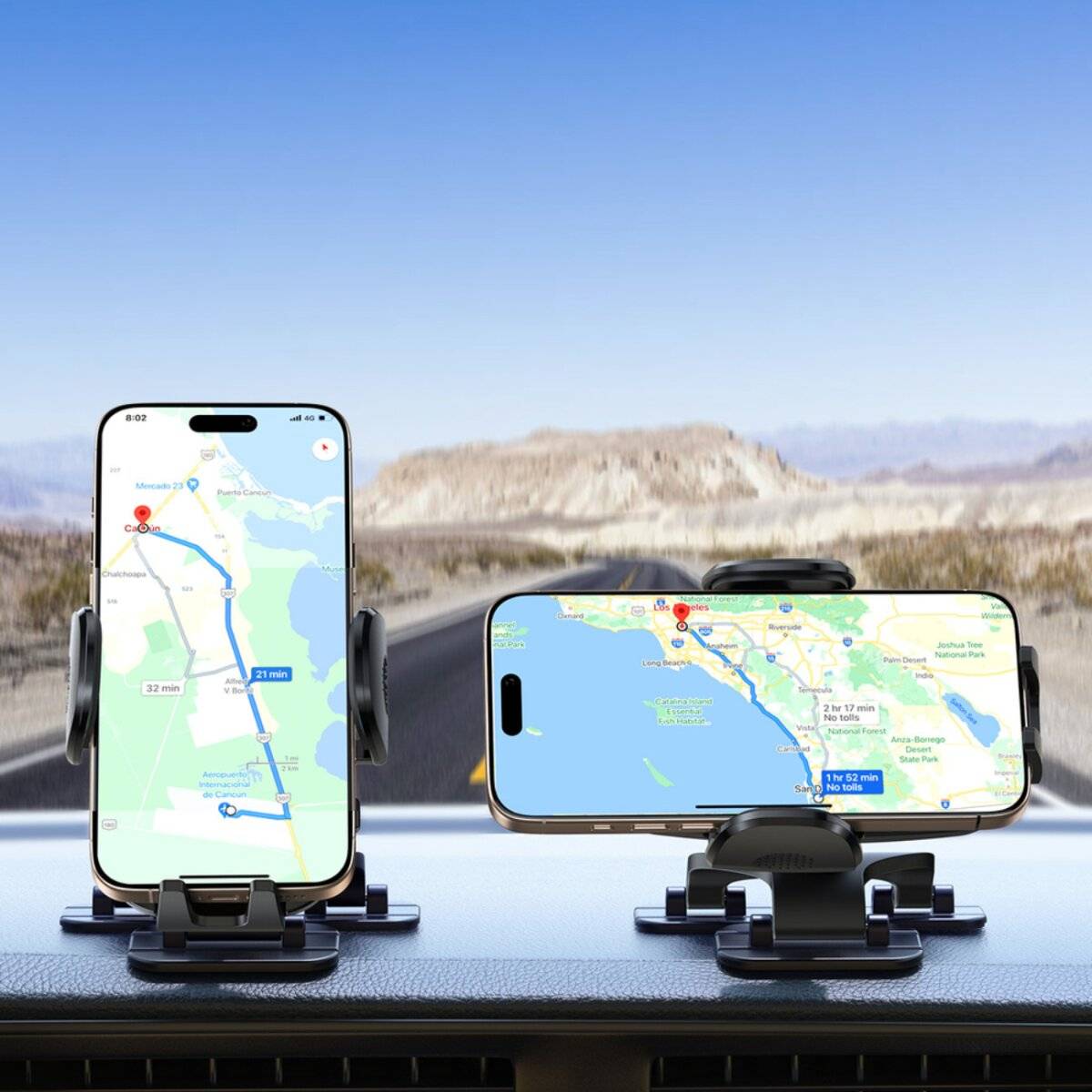 Zwei Smartphones auf einem Armaturenbrett zeigen eine GPS-Navigationsstrecke durch eine Wüstenlandschaft unter einem klaren blauen Himmel.