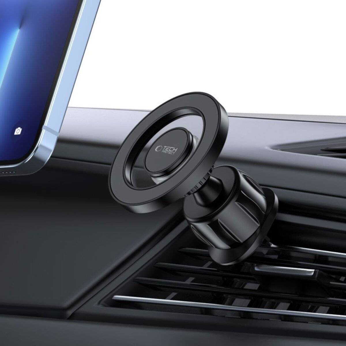 Handyhalterung, die an einer Autolüftungsöffnung angebracht ist und ein Smartphone hält. Die Halterung verfügt über eine runde magnetische Basis und ein schlankes schwarzes Design.