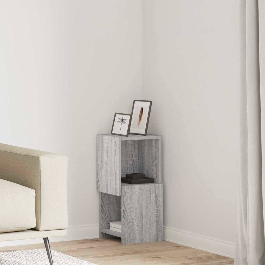 Minimalistische Schlafzimmerecke mit einem kleinen grauen Holzregal, das zwei gerahmte Bilder neben einem Bett und einem Vorhang hält.