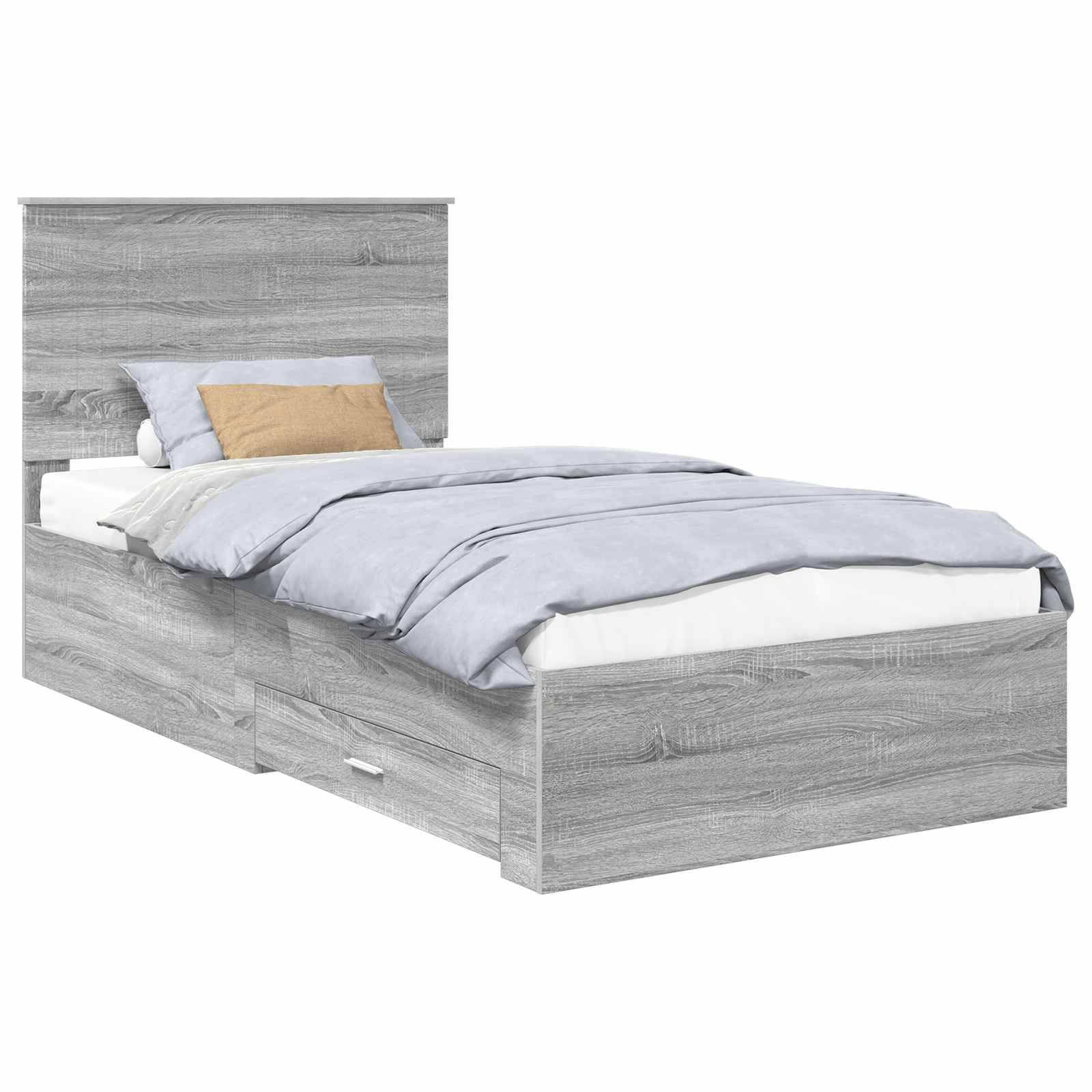 Ein grauer Holzbett mit Kopfteil und Staurageschubladen darunter, ordentlich hergerichtet mit hellblauen Bettwäsche und einem beigen Zierkissen.