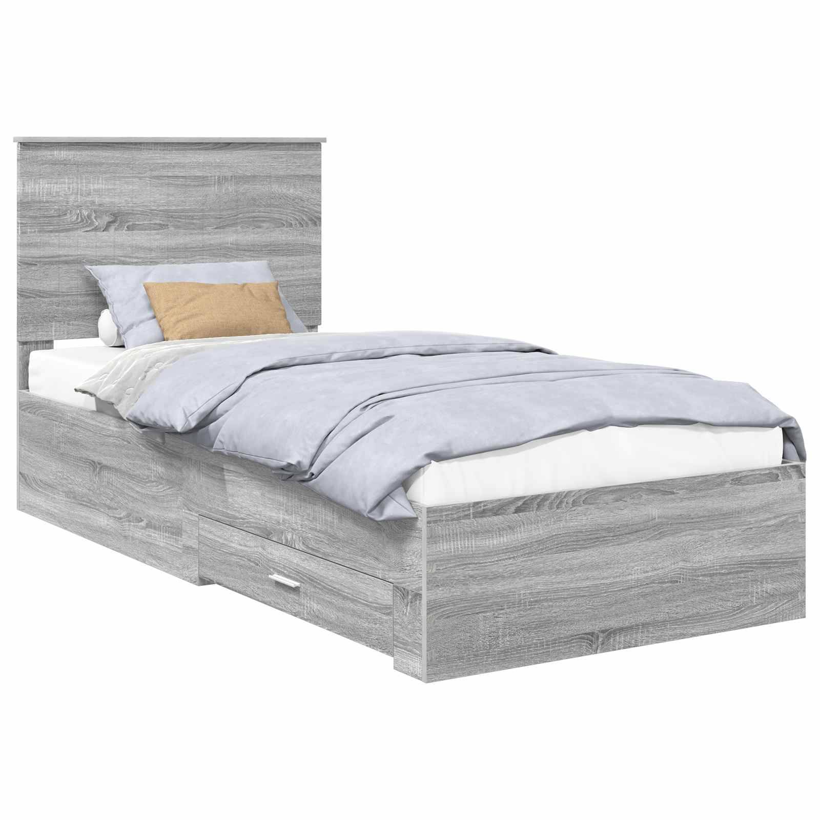 Ein grauer Holzbett mit integrierten Schubladen darunter, bedeckt mit einem hellblauen Bettdecke, weißen Laken und zwei Kissen, eines in Beige und eines in Blau.