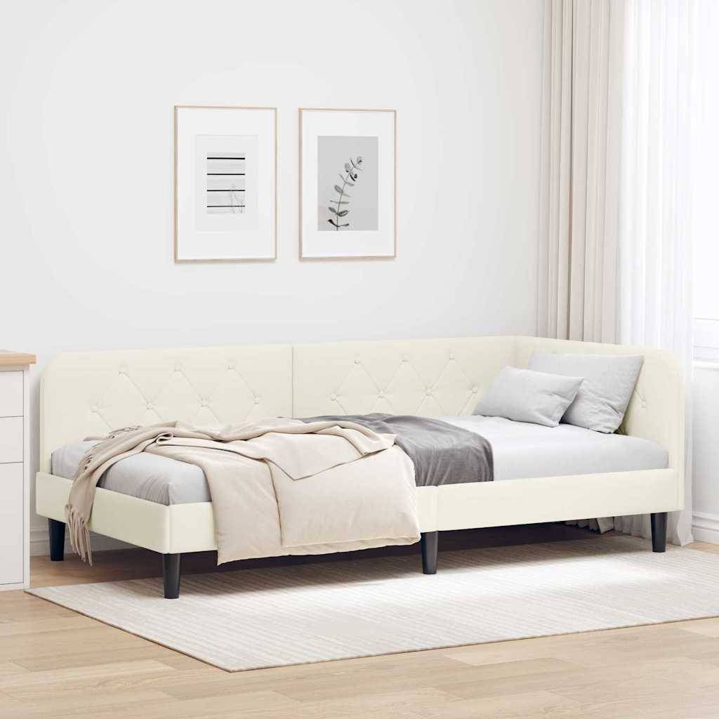 Ein modernes Schlafzimmer präsentiert ein cremefarbenes gepolstertes Bett mit grauer und beiger Bettwäsche und zwei gerahmte minimalistische Kunstwerke an der Wand.