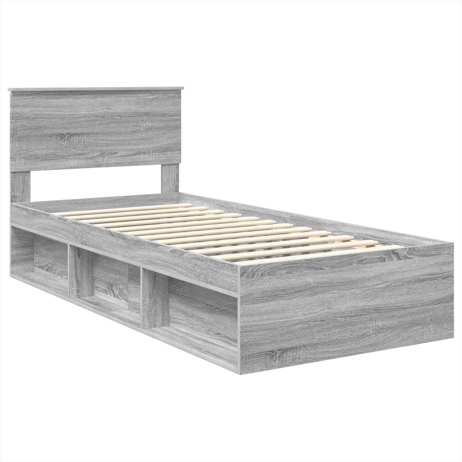Ein grauer Holzbettrahmen mit Latten-Untergestell und drei offenen Stauraumfächern darunter.